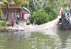 Fisherman's cleaning nets - a backwater scene.